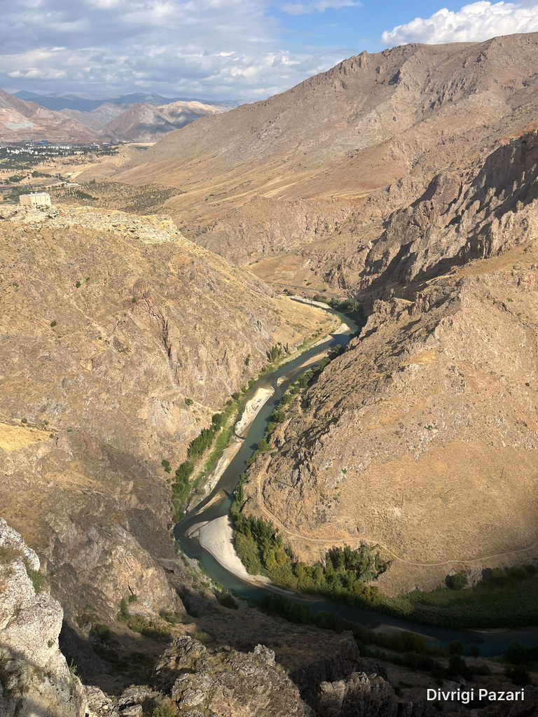 The Çaltı winding between rocky slopes, with trees along its banks