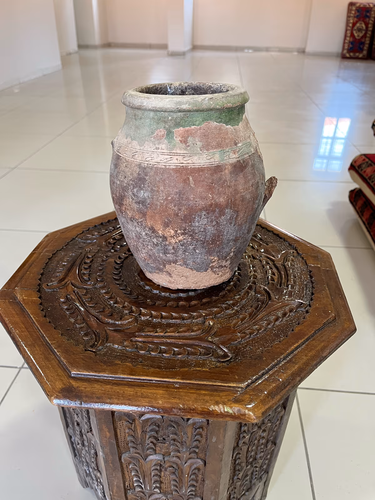 Wide-bodied earthen vessel with a narrow mouth